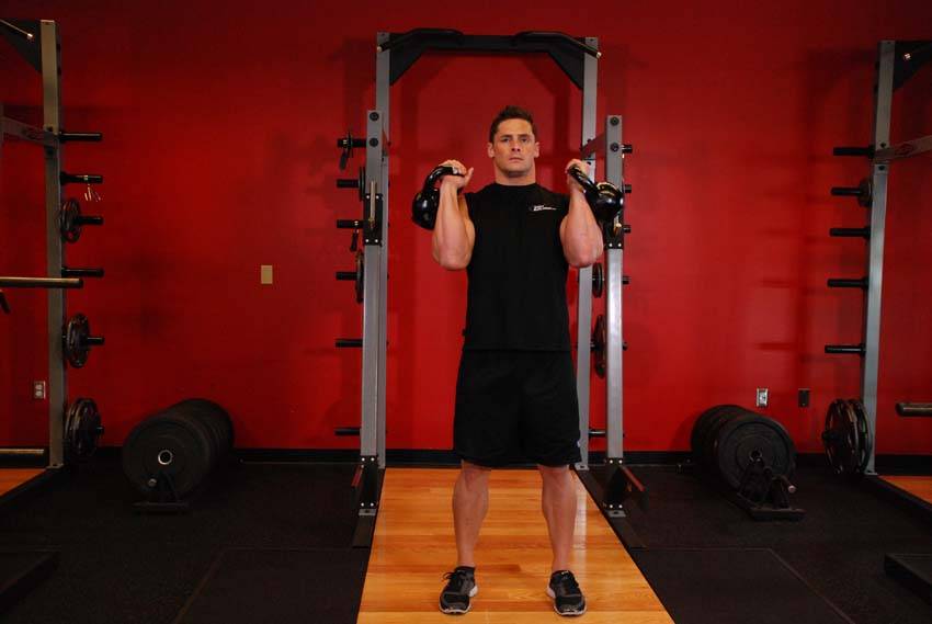 Alternating Kettlebell Press, position 1 of 2