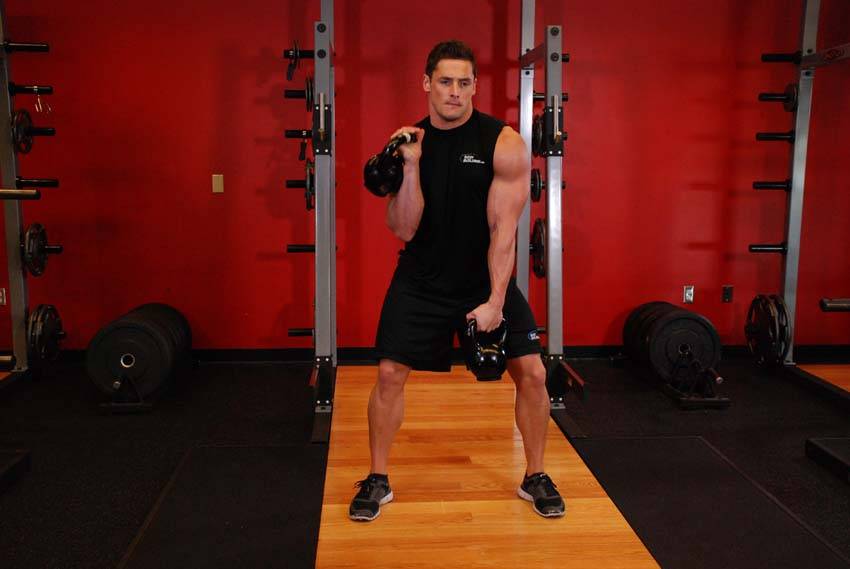 Double Kettlebell Alternating Hang Clean, position 2 of 2