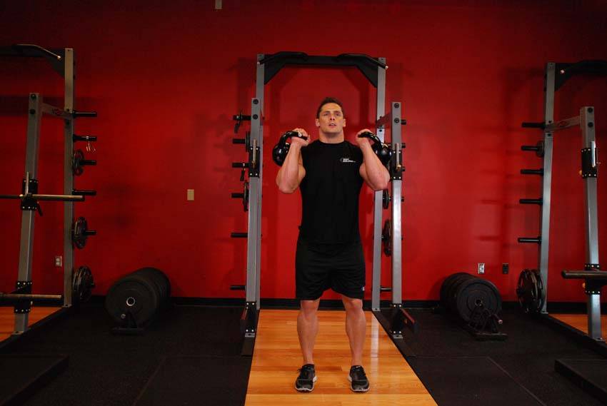 Double Kettlebell Push Press, position 1 of 2