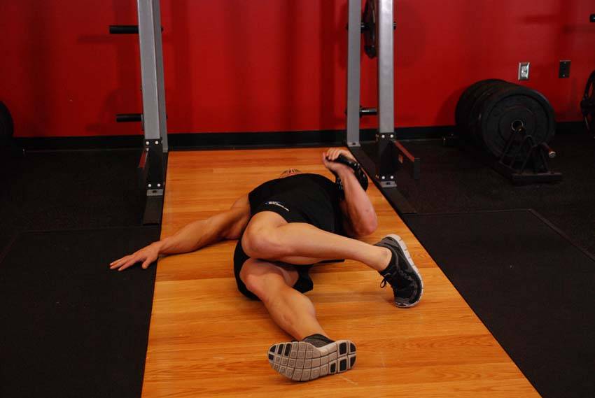Extended Range One-Arm Kettlebell Floor Press, position 1 of 2