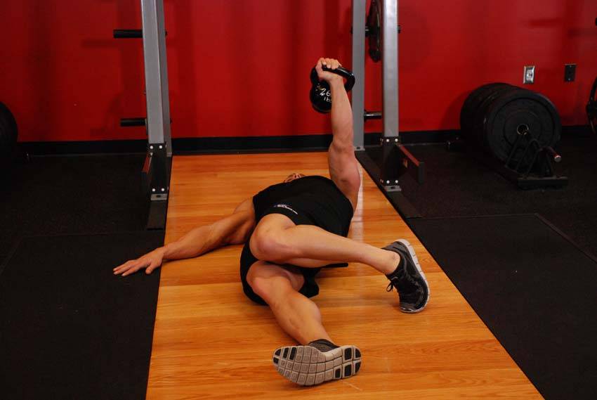 Extended Range One-Arm Kettlebell Floor Press, position 2 of 2