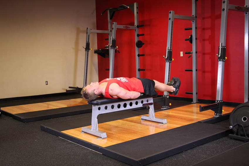 Flat Bench Lying Leg Raise, position 1 of 2