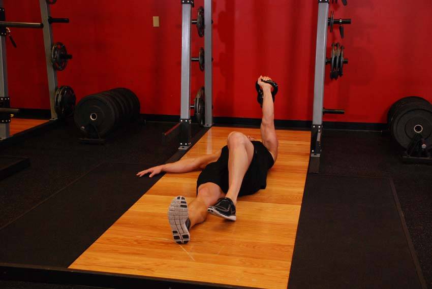 Kettlebell Turkish Get-Up (Squat style), position 1 of 2