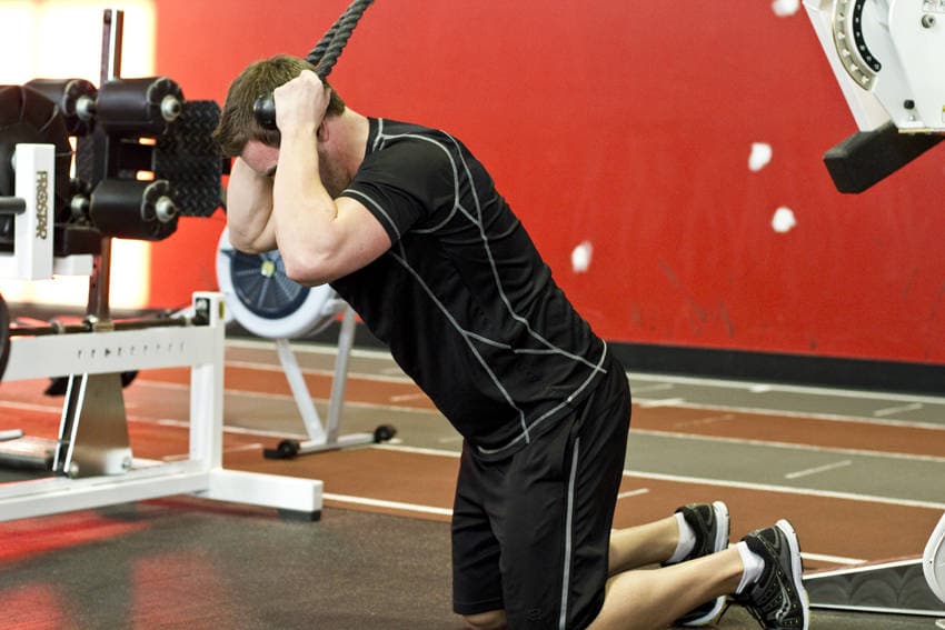 Kneeling Cable Crunch With Alternating Oblique Twists, position 1 of 2