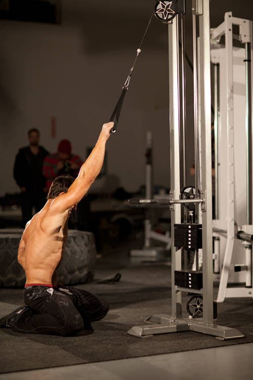 Kneeling Single-Arm High Pulley Row, position 1 of 2