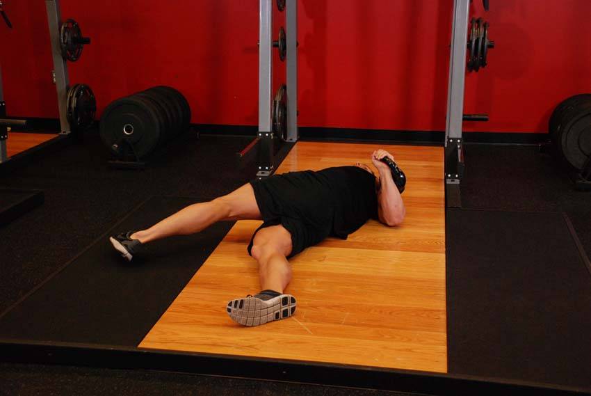 Leg-Over Floor Press, position 1 of 2