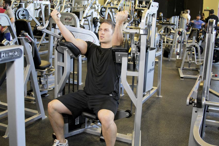 Machine Bicep Curl, position 1 of 2