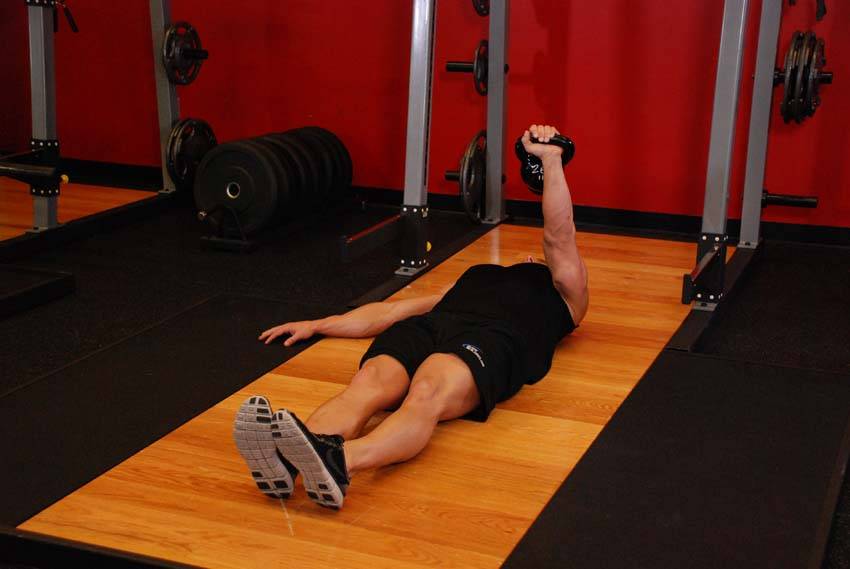 One-Arm Kettlebell Floor Press, position 2 of 2