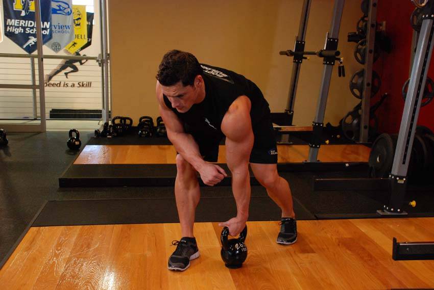 One-Arm Kettlebell Row, position 1 of 2