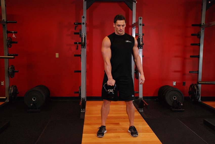 One-Arm Kettlebell Split Snatch, position 1 of 2