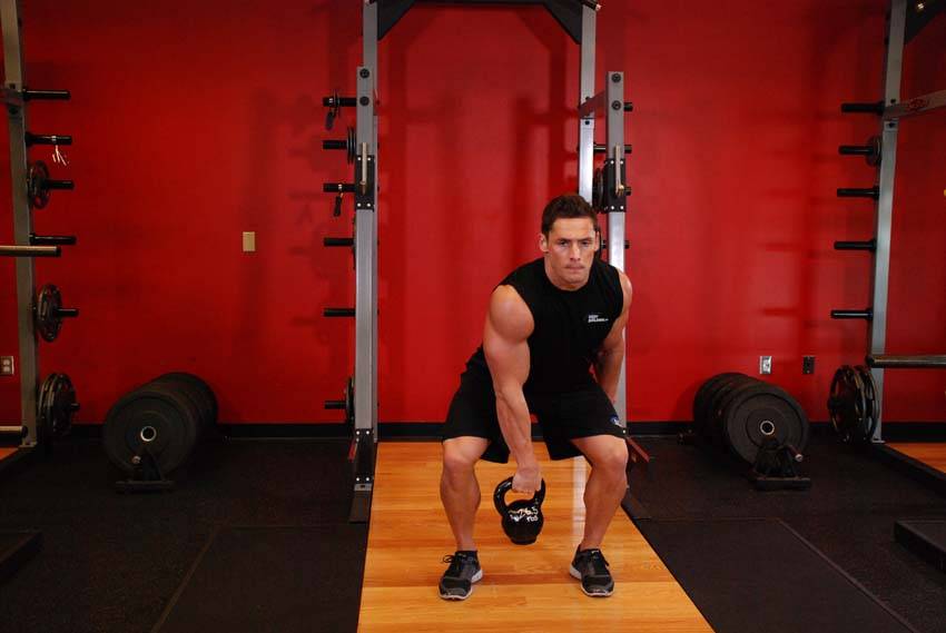 One-Arm Kettlebell Split Snatch, position 2 of 2