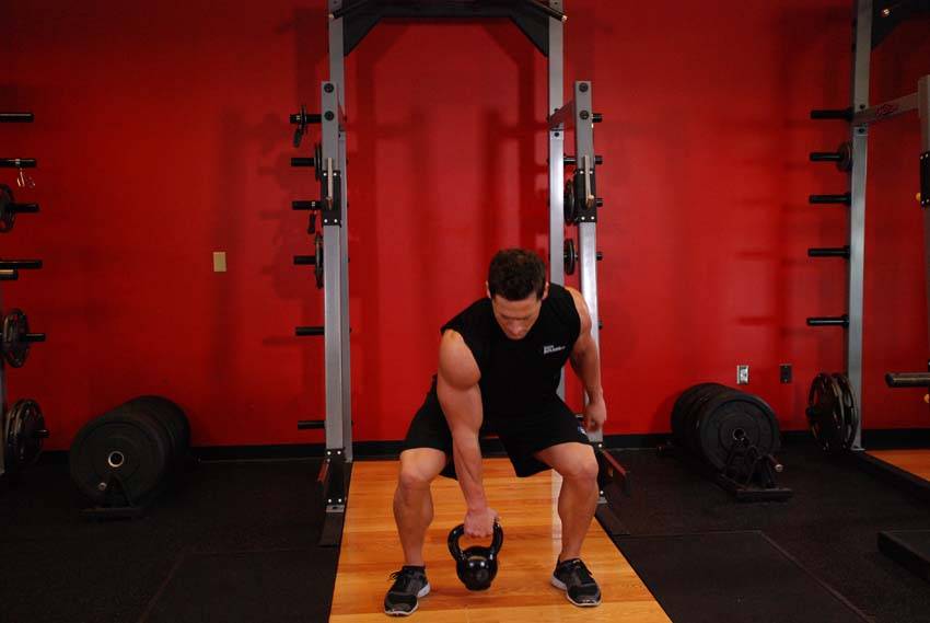 One-Arm Open Palm Kettlebell Clean, position 1 of 2