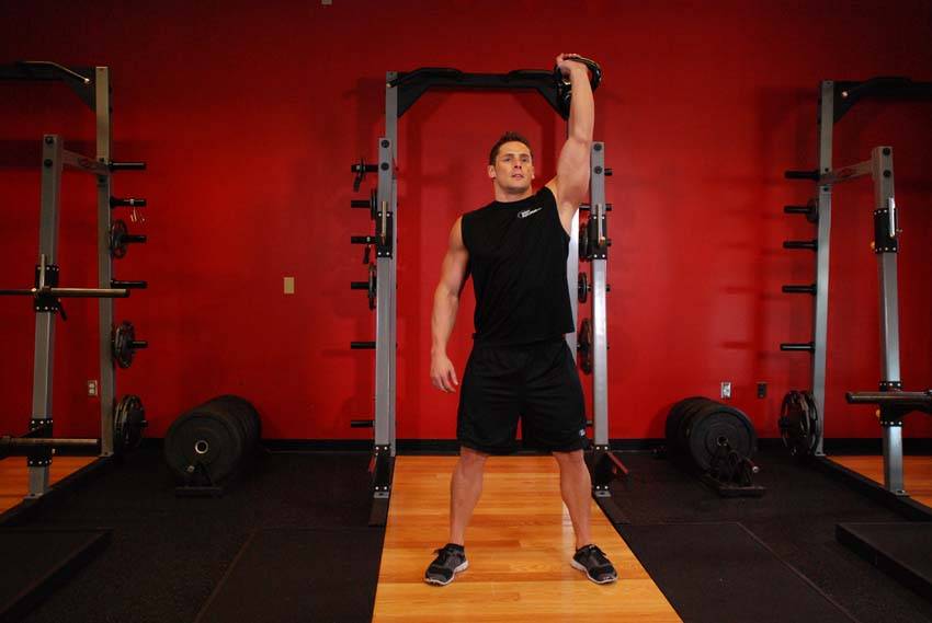 One-Arm Overhead Kettlebell Squats, position 1 of 2