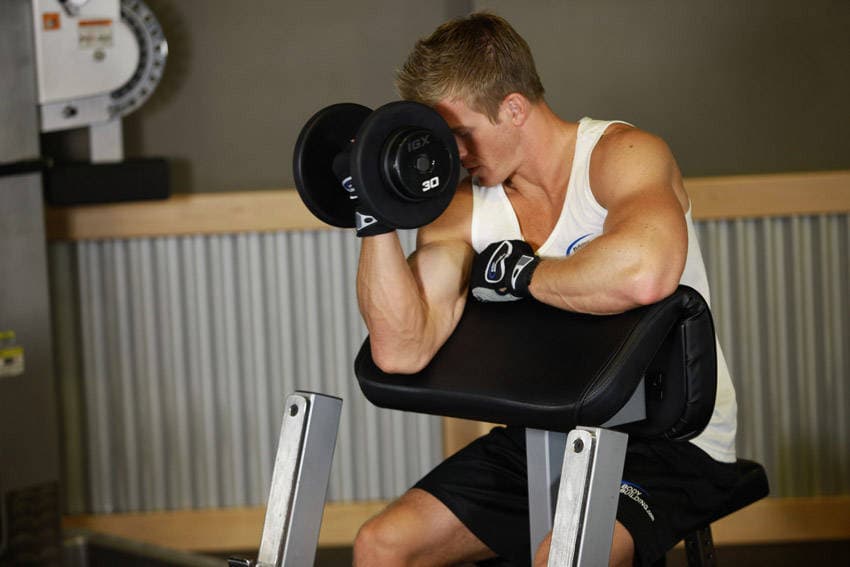 One Arm Dumbbell Preacher Curl, position 2 of 2