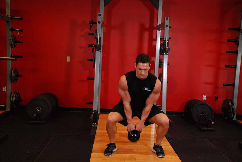 Open Palm Kettlebell Clean, position 1 of 2