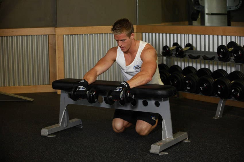 Palms-Down Dumbbell Wrist Curl Over A Bench, position 1 of 2