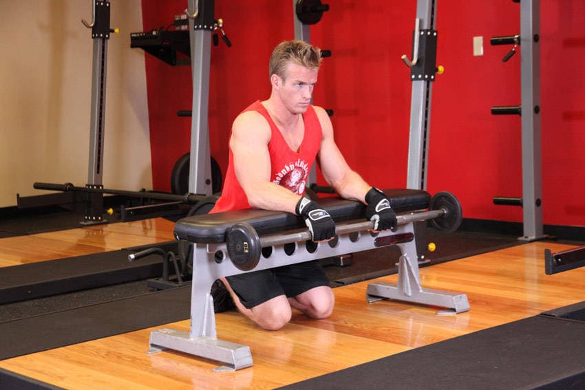 Palms-Down Wrist Curl Over A Bench, position 1 of 2