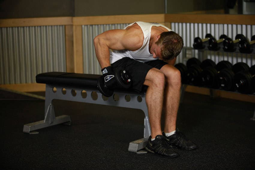 Seated Bent-Over One-Arm Dumbbell Triceps Extension, position 1 of 2