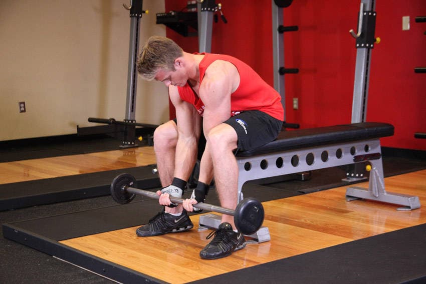 Seated Close-Grip Concentration Barbell Curl, position 1 of 2