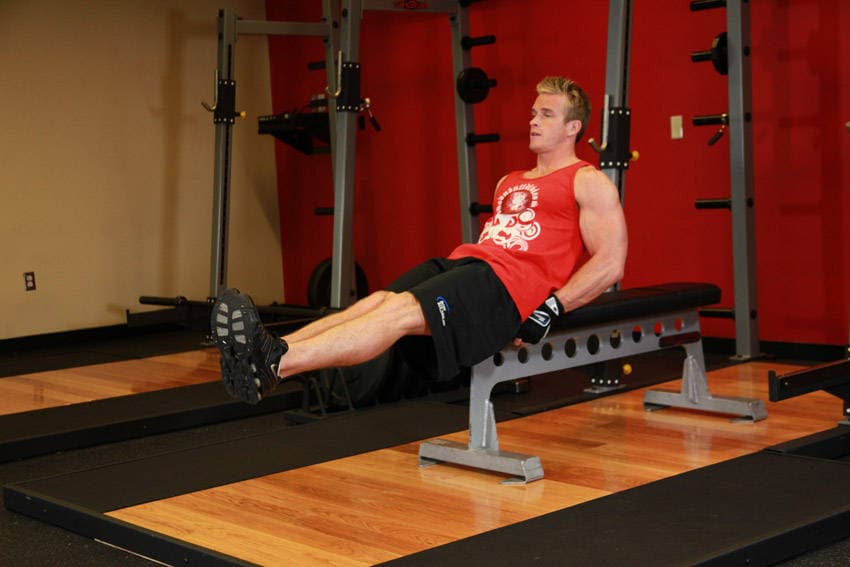 Seated Flat Bench Leg Pull-In, position 1 of 2
