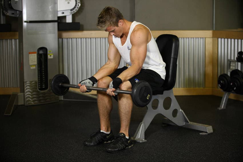 Seated Palm-Up Barbell Wrist Curl, position 1 of 2