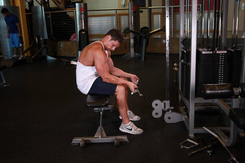 Seated Two-Arm Palms-Up Low-Pulley Wrist Curl, position 1 of 2