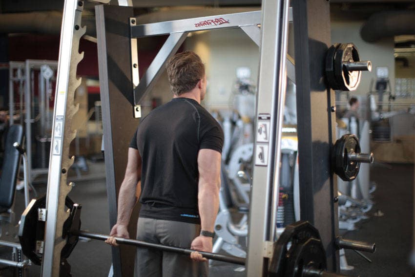 Smith Machine Behind the Back Shrug, position 1 of 2