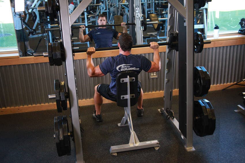 Smith Machine Overhead Shoulder Press, position 1 of 2