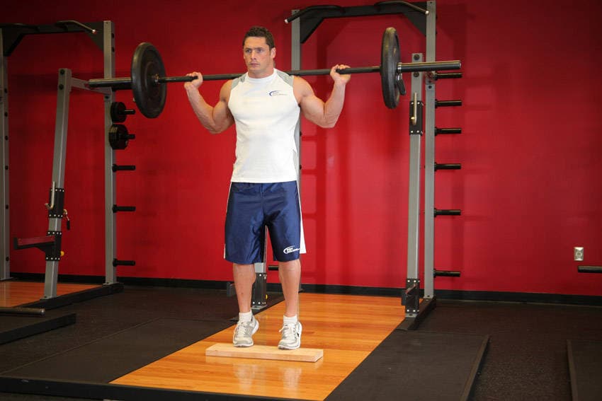 Standing Barbell Calf Raise, position 1 of 2