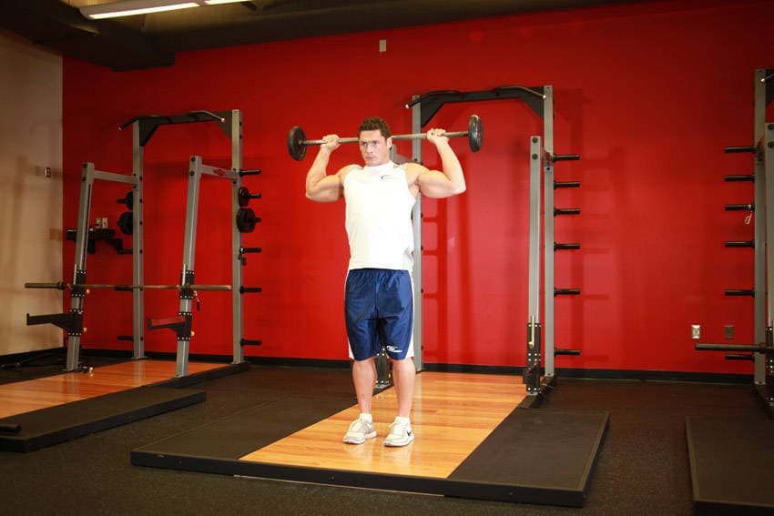 Standing Barbell Press Behind Neck, position 1 of 2