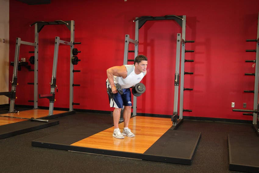 Standing Bent-Over Two-Arm Dumbbell Triceps Extension, position 1 of 2