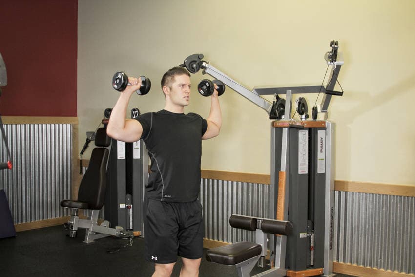 Standing Dumbbell Press, position 1 of 2