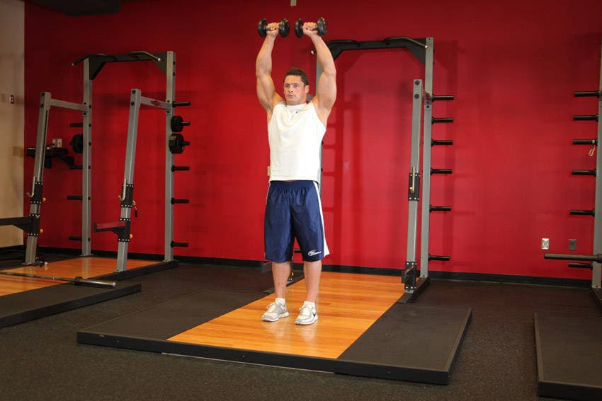 Standing Dumbbell Straight-Arm Front Delt Raise Above Head, position 2 of 2