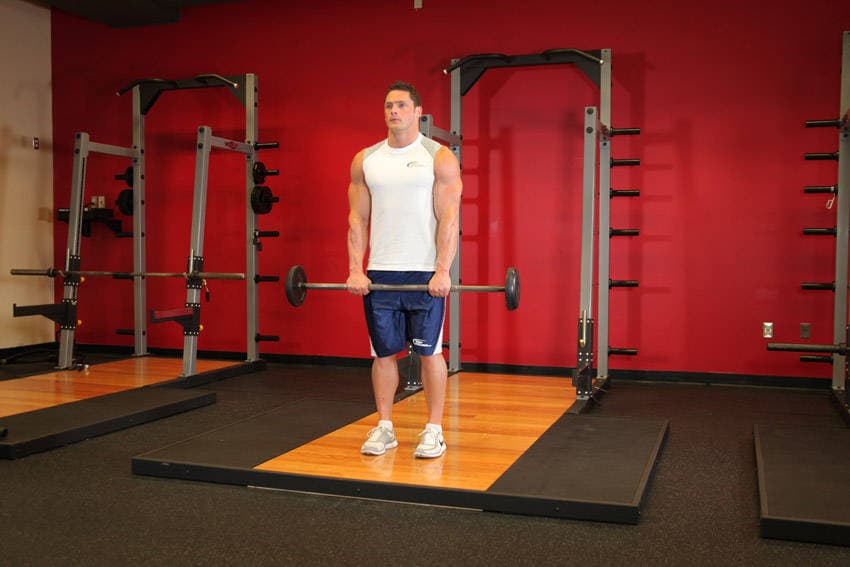 Standing Front Barbell Raise Over Head, position 1 of 2