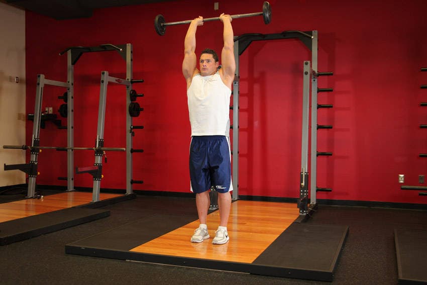 Standing Overhead Barbell Triceps Extension, position 2 of 2