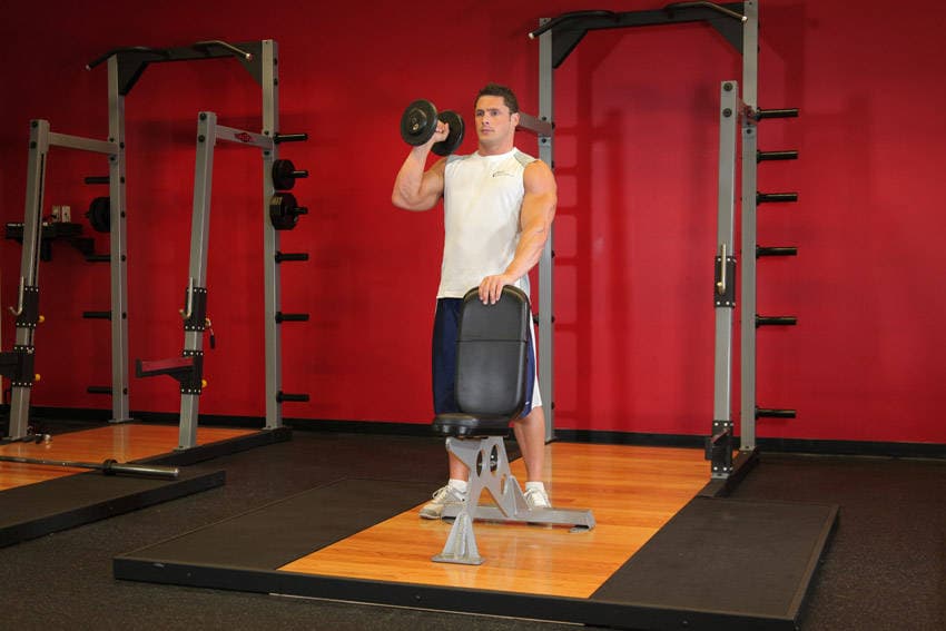 Standing Palm-In One-Arm Dumbbell Press, position 1 of 2