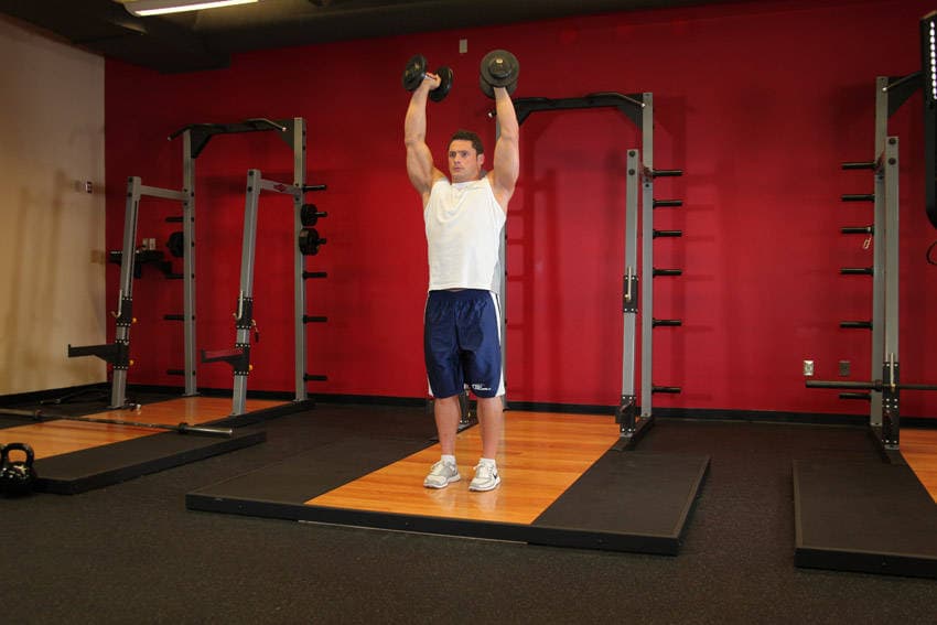 Standing Palms-In Dumbbell Press, position 1 of 2