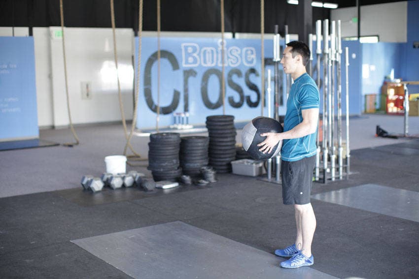 Standing Two-Arm Overhead Throw, position 1 of 2