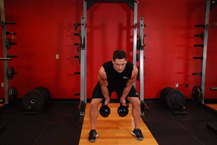 Two-Arm Kettlebell Clean, position 1 of 2