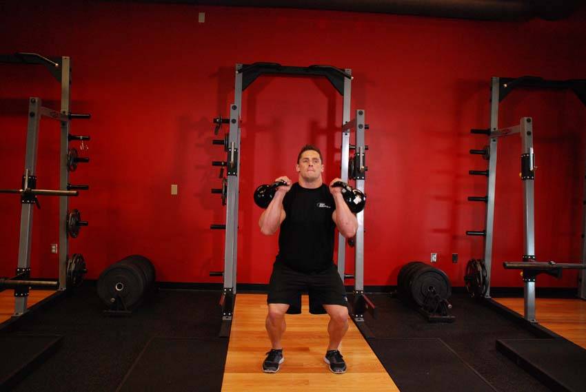 Two-Arm Kettlebell Jerk, position 1 of 2