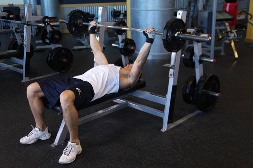 Wide-Grip Barbell Bench Press, position 1 of 2