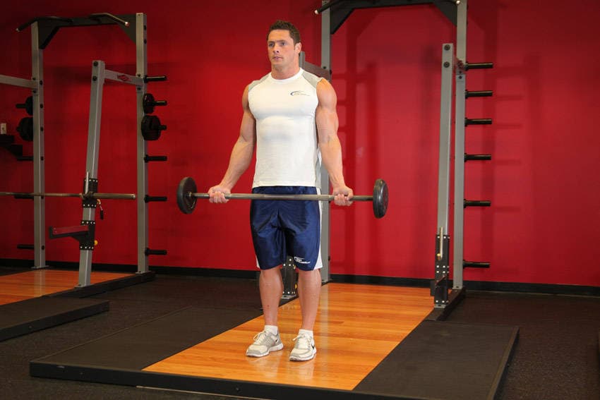 Wide-Grip Standing Barbell Curl, position 1 of 2